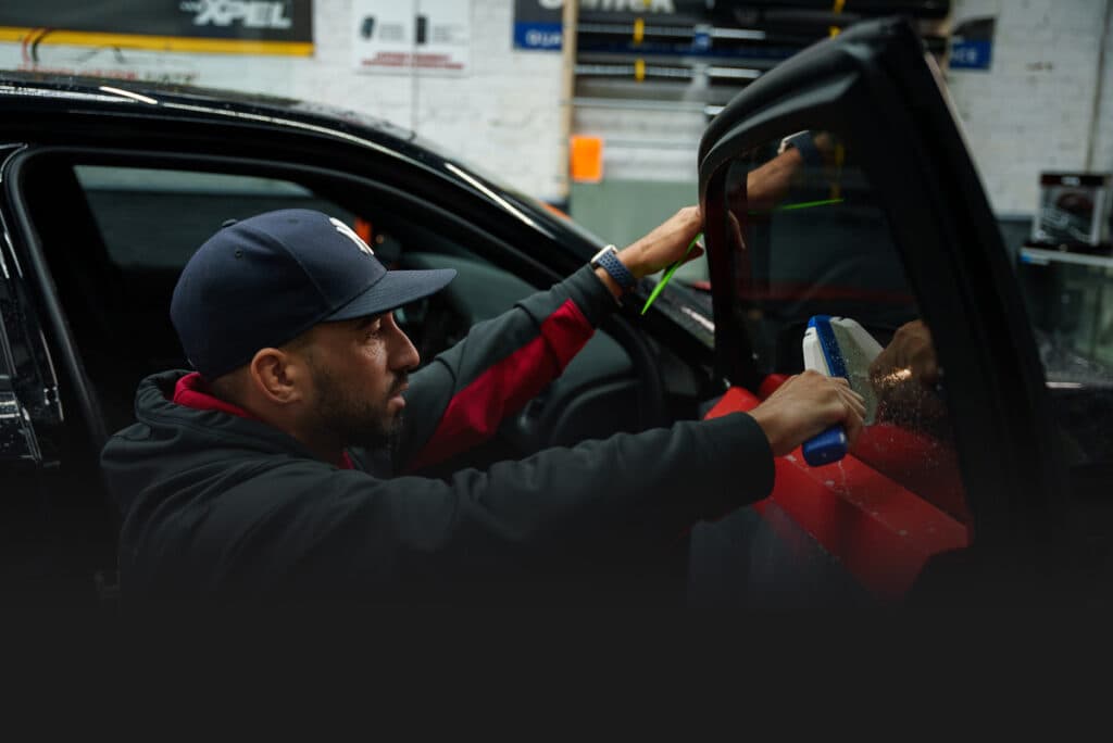 Revolution Tints installer applying window film